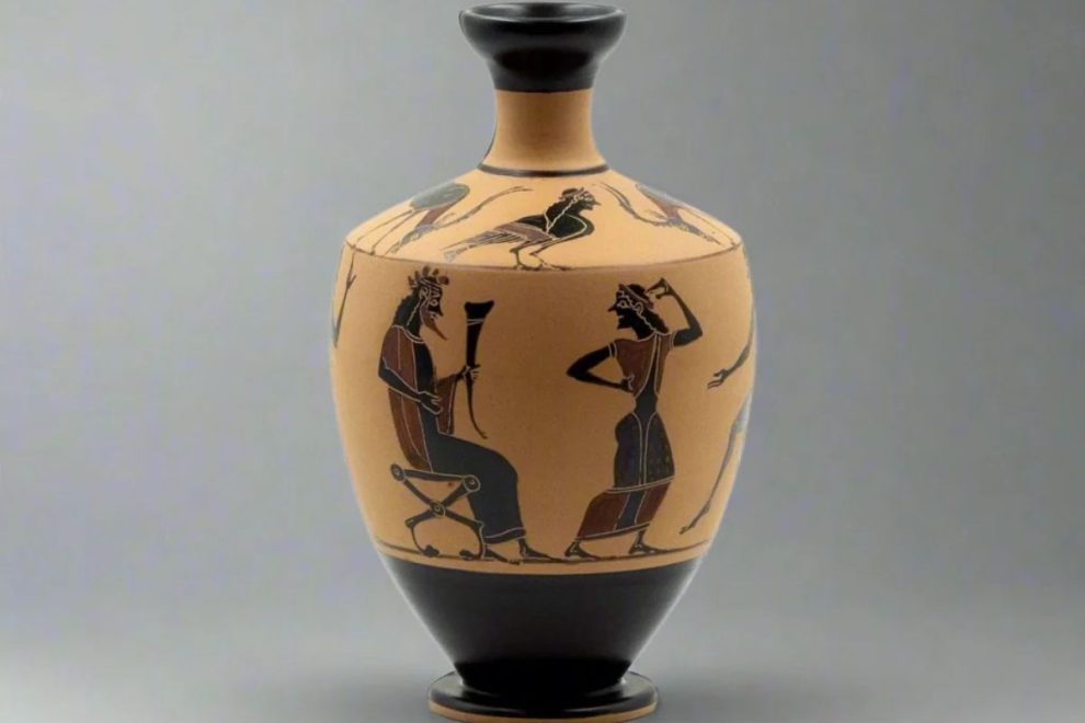 An ancient Greek vase featuring black-figure artwork depicting a seated figure and a standing dancer in a classical scene.